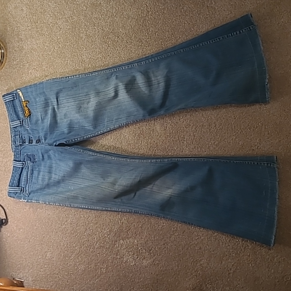 Women's blue jeans artfully distressed and repaired 10/12